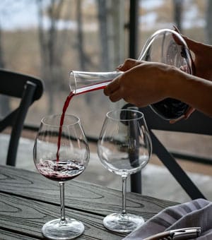 Someone decanting red wine