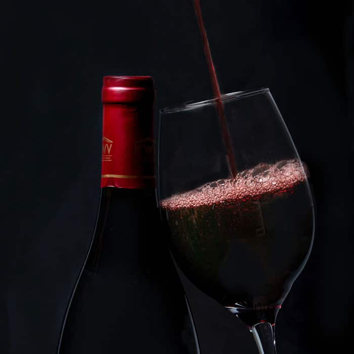 red wine bottle poured into a glass